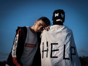 Photo by Iluha Zavaley man in white and black jacket beside man in white and black crew neck shirt under